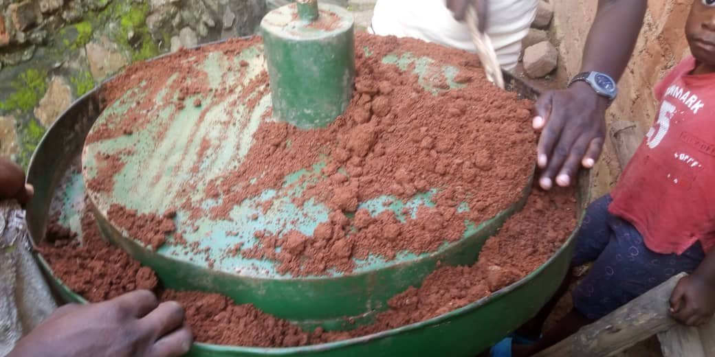 Biomass material being processed using production equipment